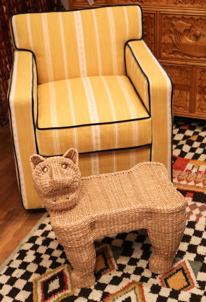 yellow chair with cat shaped whicker foot rest