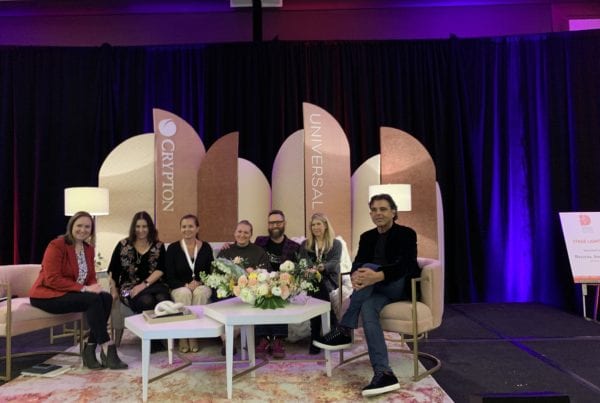 Group of people sitting on sofa and chairs at Universal event